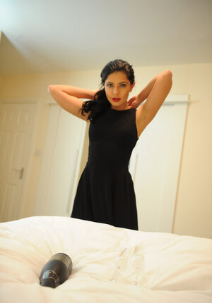 Cute brunette takes off black dress and red underwear posing nude on the bed