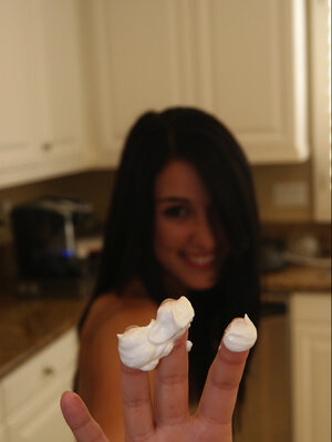 Undressed brunette lady friend comes to the kitchen to play with whipped cream