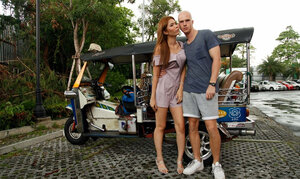 Glabrous lad and cute Thai teen have fine outdoor photoshoot near rickshaw