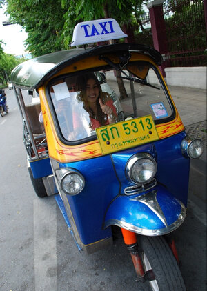 Joyful Thai minx poses near white fellow and additionally his impressive auto rickshaw