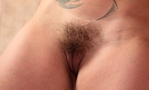 Kathia Nobili runs a comb thru her beaver before taking a bath