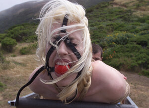 Cowgirl gets whipped while dragging her master up a hill