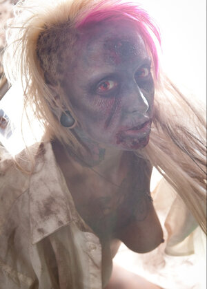 Aroused zombie with hooters tears off her clothes in fetish pics