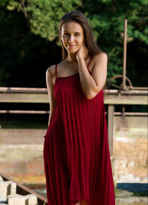 Alisa Amore disrobes to pose nude near a dam