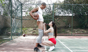 Alexis Rodriguez gives a blowjobs to a long black phallus outside