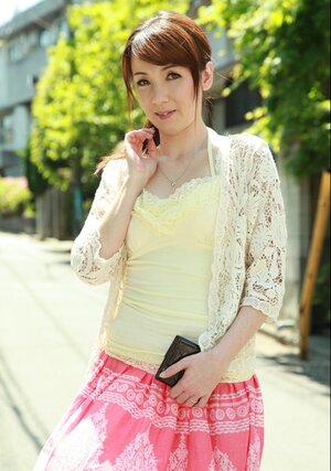 Far eastern beauty with red hair seductively walks on sunny street of big city