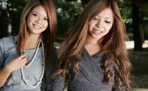 Aroused Japanese girlfriends make out during promenade on city streets