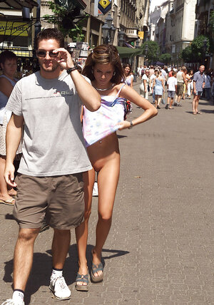 Bitch in high heels gets naked and moreover poses in the nude on the crowded street