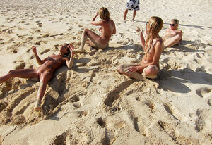 Group of young and fresh slutty girls pose entirely undressed on the beach with no shame