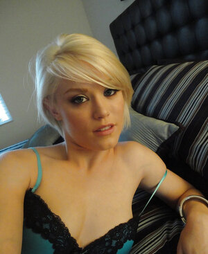 Blonde babe in green underwear takes nude selfies in front of a large mirror