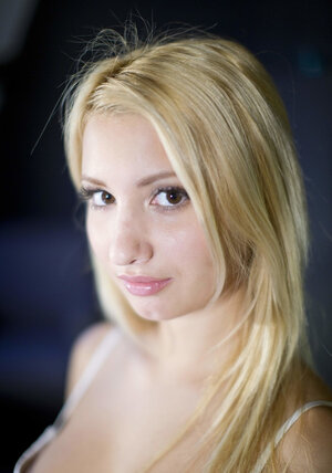 Seducing blonde strips naked and spreads legs to show her sweet vagina