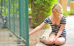 Immature woman in a striped dress extremely casually exposes her vag in the town