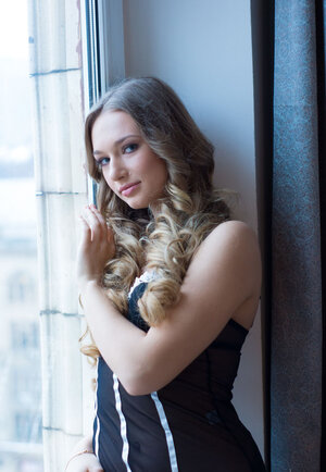 Romantic blonde legal teen takes off black underwear while reading on the windowsill