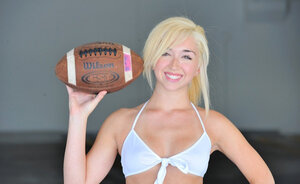 Youthful dame changes clothes to go playing volleyball in white stockings only