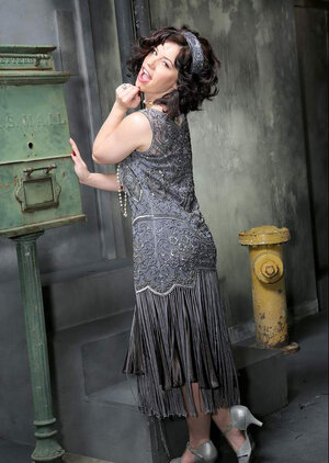 Breathtaking black-haired sexpot in retro outfit flashes her bare bum and love hole