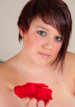 Pudgy cutie with beads shakes her enormous natural tits on the bed of roses