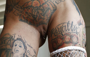 Inked femme fatale in fishnet outfit puts buttplug in booty and moreover vibrator in twat
