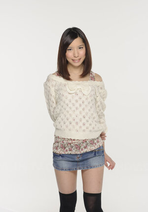 Young-looking Japanese chick poses in short skirt that accentuates her long legs