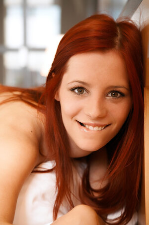 Chesty ginger hussy enjoys posing undressed to show bra buddies and cum bucket on the bed